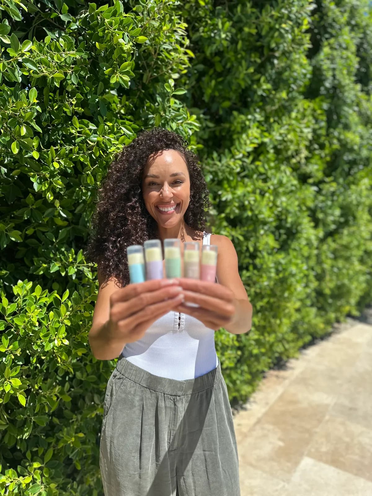 Numbrrrz founder showcasing the full lip balm collection